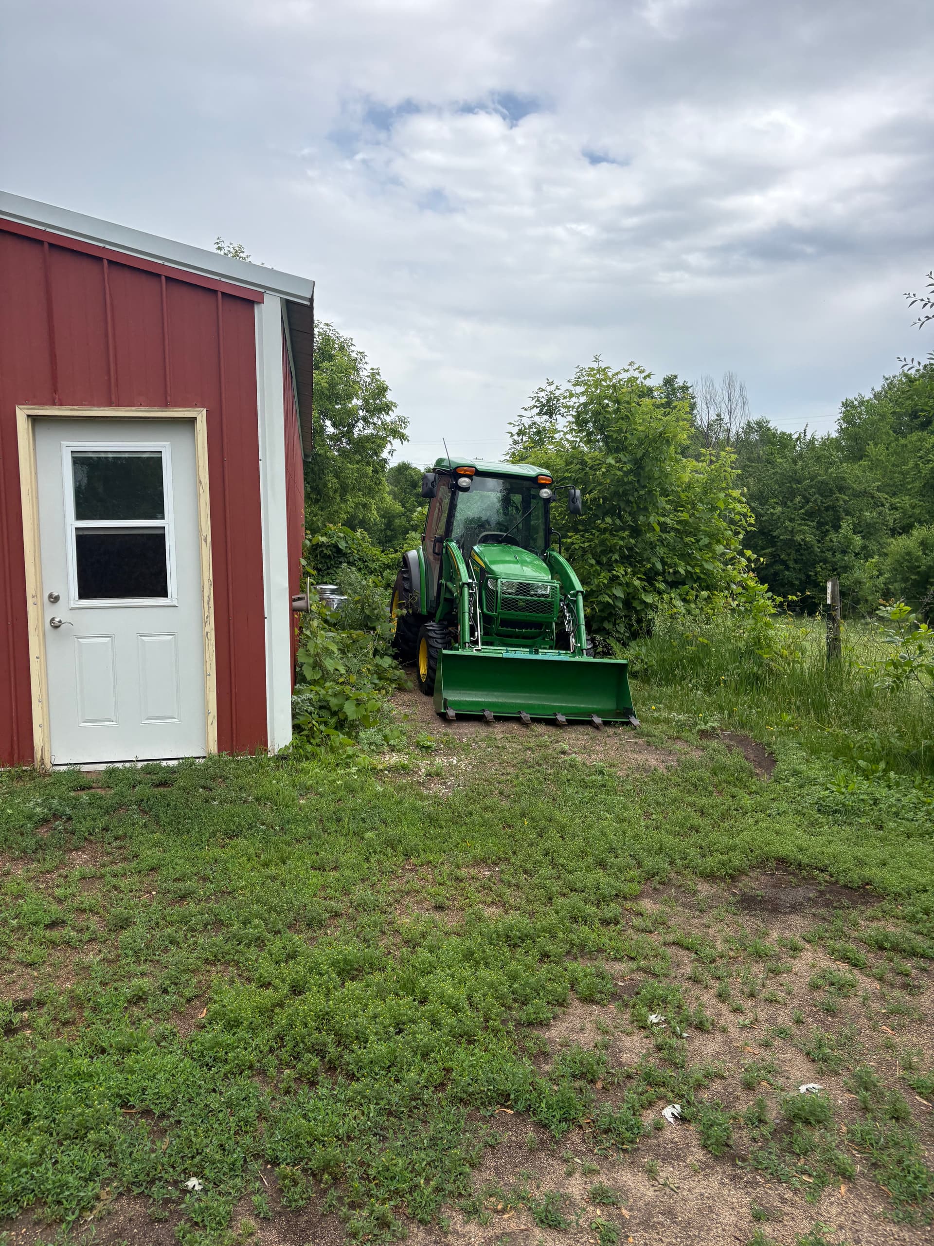 Overgrown Land Cleared and Graded for a Rock Parking Pad image